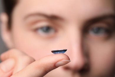 Photo of Woman with blue color contact lens, closeup. Selective focus