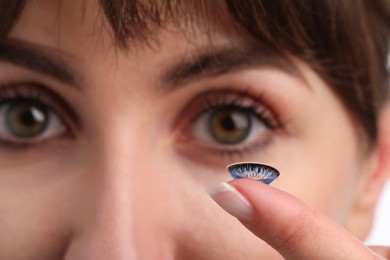 Photo of Woman with blue color contact lens, closeup. Selective focus