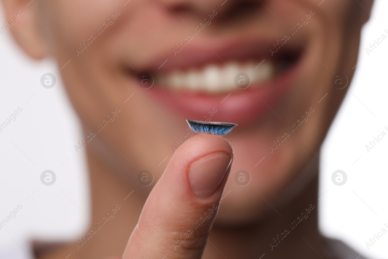 Photo of Man with color contact lens on light background, closeup. Selective focus