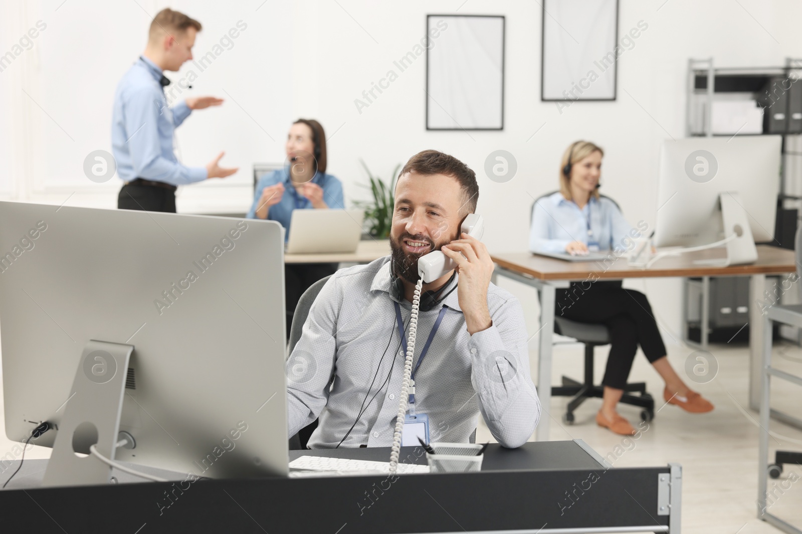 Photo of Technical support call center. Team of operators working in office