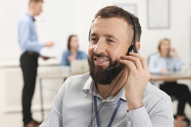 Photo of Technical support call center. Smiling operator working in office