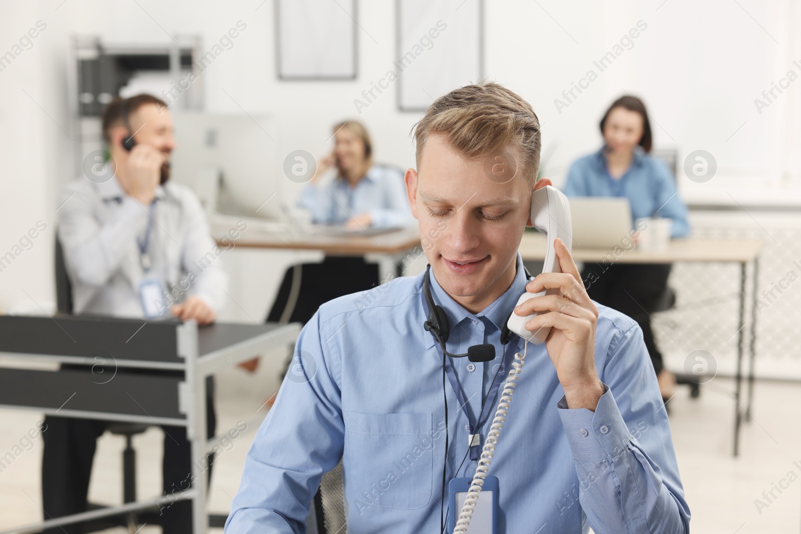 Photo of Technical support call center. Operator working in office