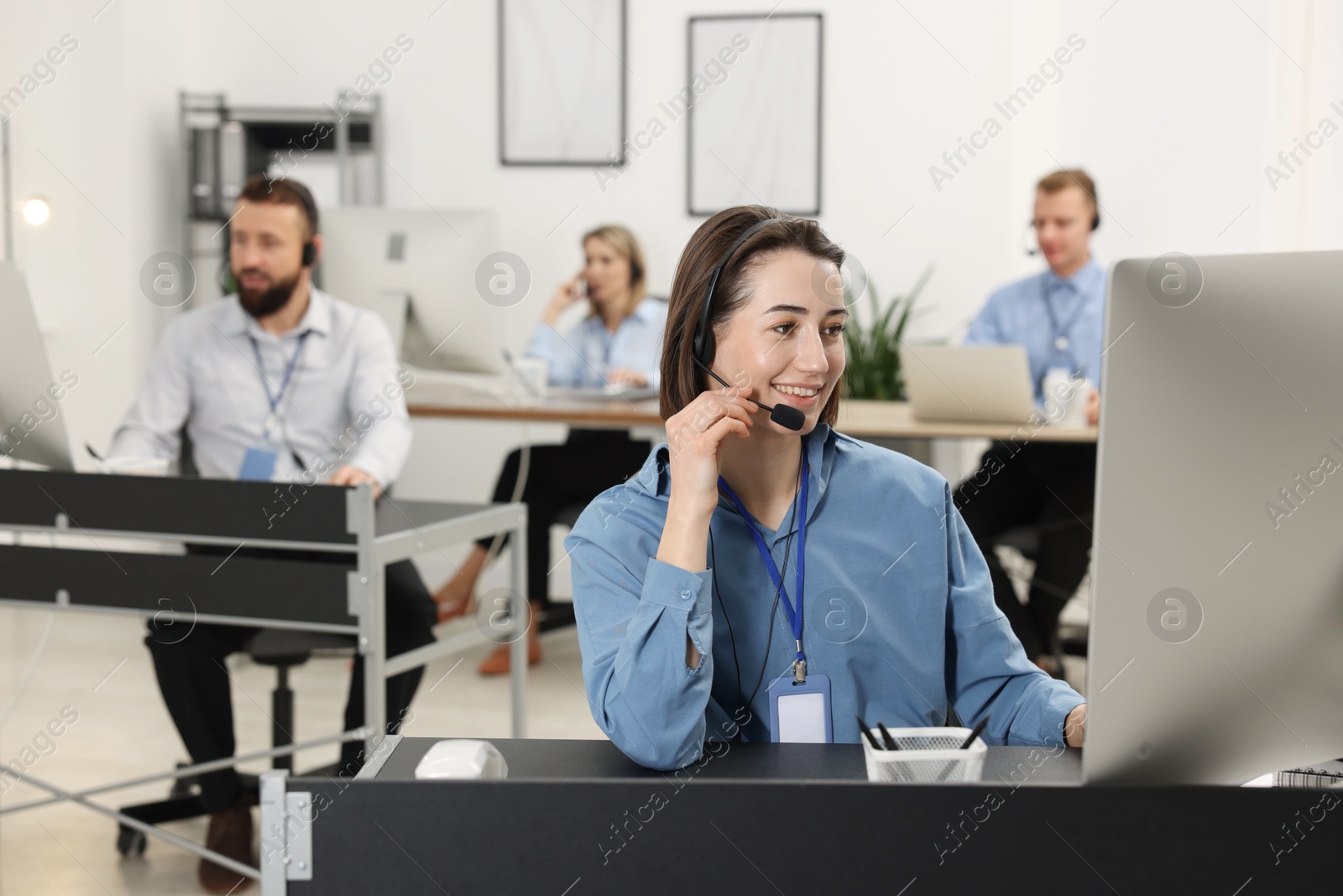 Photo of Technical support call center. Team of operators working in office