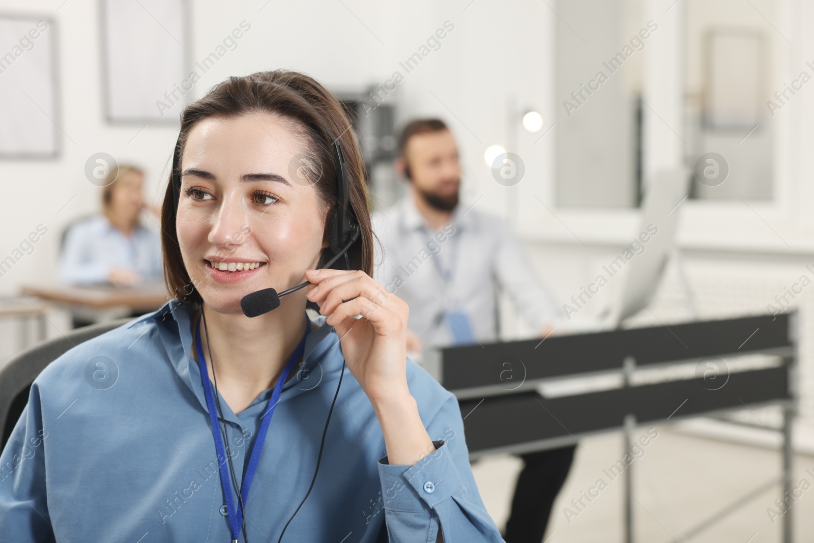 Photo of Technical support call center. Smiling operator working in office. Space for text