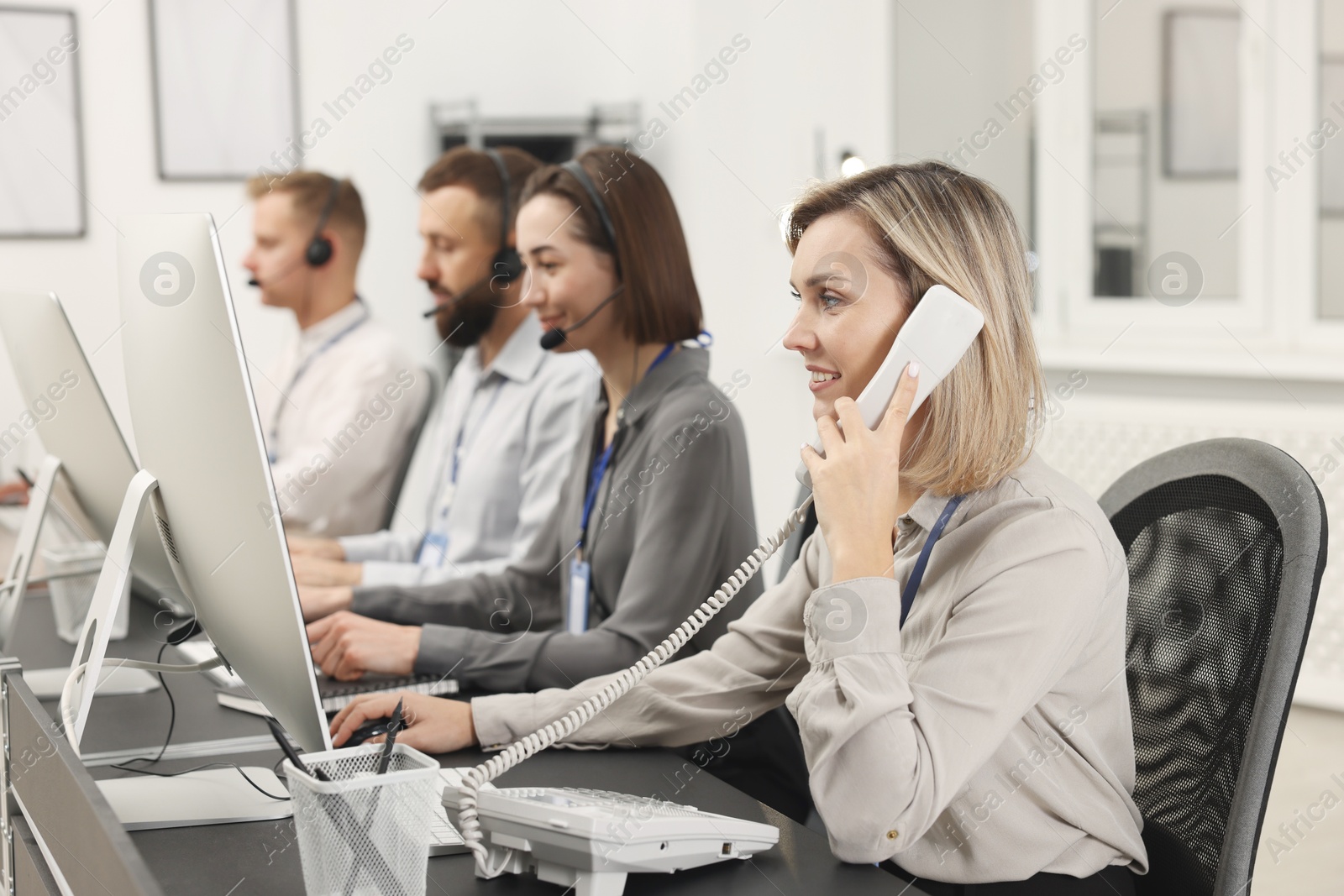 Photo of Technical support call center. Team of operators working in office