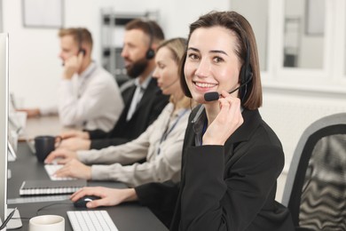 Photo of Technical support call center. Team of operators working in office