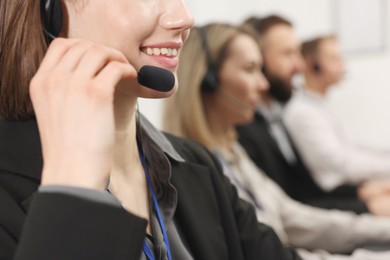 Photo of Technical support call center. Team of operators working in office, selective focus