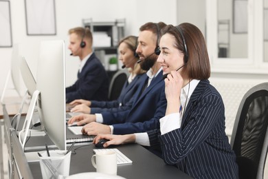 Photo of Technical support call center. Team of operators working in office