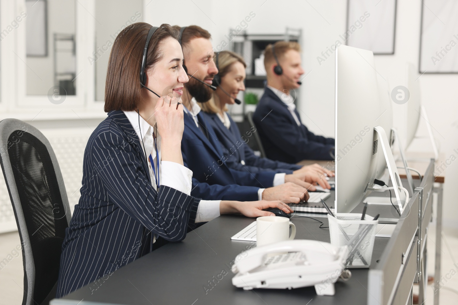 Photo of Technical support call center. Team of operators working in office