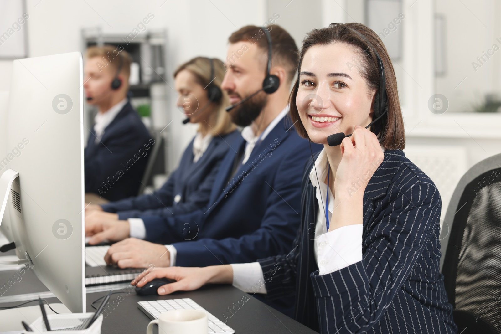 Photo of Technical support call center. Team of operators working in office