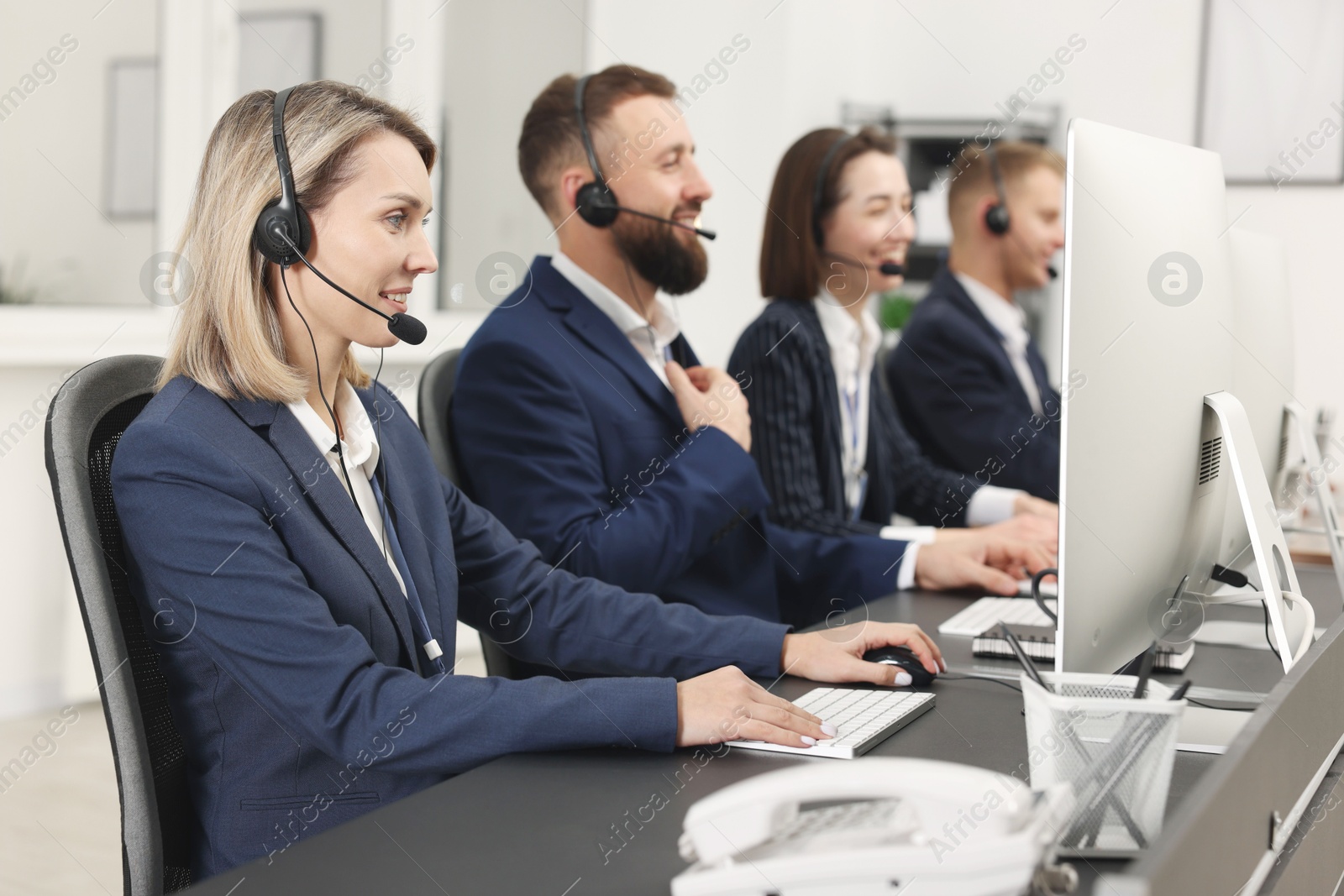 Photo of Technical support call center. Team of operators working in office