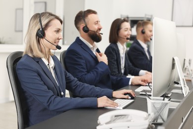 Photo of Technical support call center. Team of operators working in office