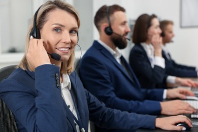 Photo of Technical support call center. Team of operators working in office