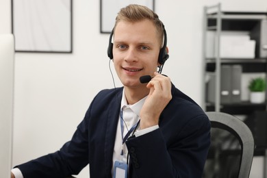 Photo of Technical support call center. Portrait of smiling operator in office