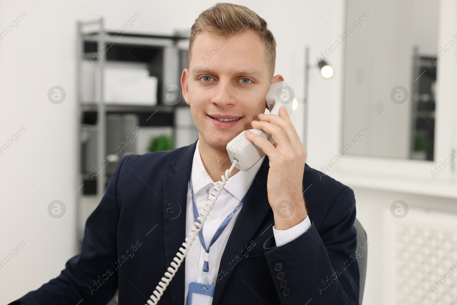 Photo of Technical support call center. Portrait of smiling operator in office