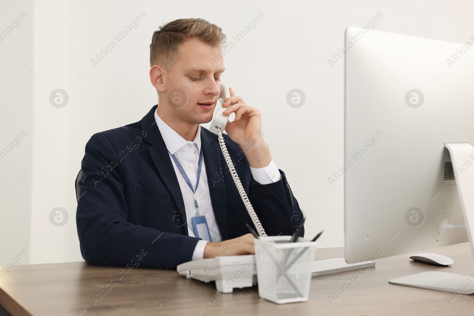 Photo of Technical support call center. Operator working at table in office