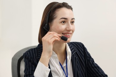 Photo of Technical support call center. Portrait of smiling operator in office