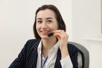 Photo of Technical support call center. Portrait of smiling operator in office