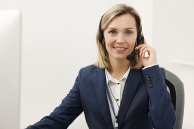 Photo of Technical support call center. Portrait of smiling operator in office