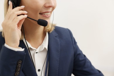 Photo of Technical support call center. Smiling operator working indoors, closeup. Space for text