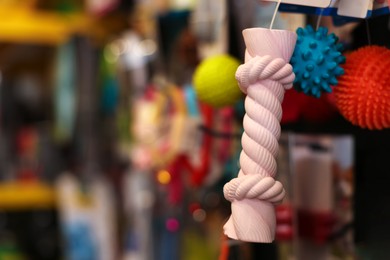 Photo of Toys on display in pet shop, closeup. Space for text