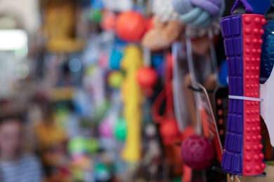 Photo of Toys on display in pet shop, closeup. Space for text