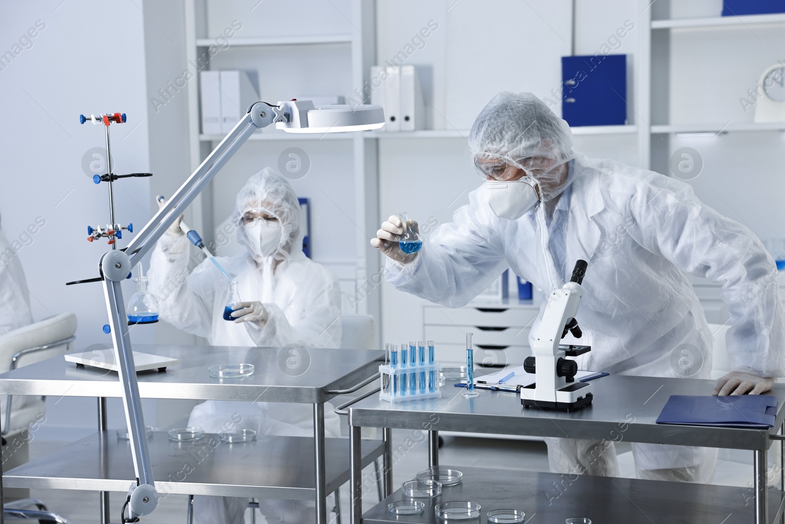 Photo of Scientists wearing protective suits while working in laboratory