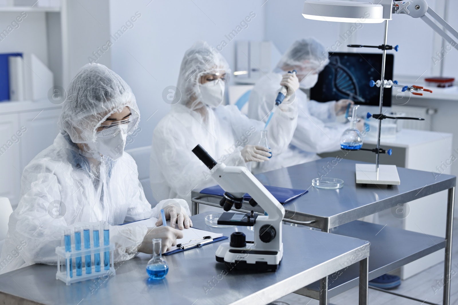 Photo of Scientists wearing protective suits while working in laboratory