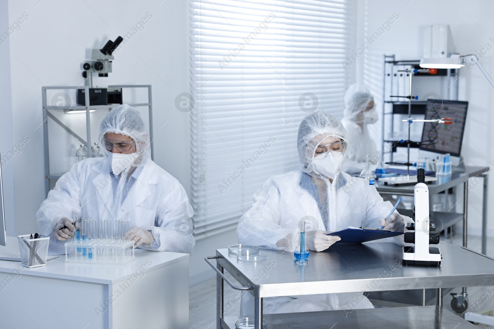 Photo of Scientists wearing protective suits while working in laboratory