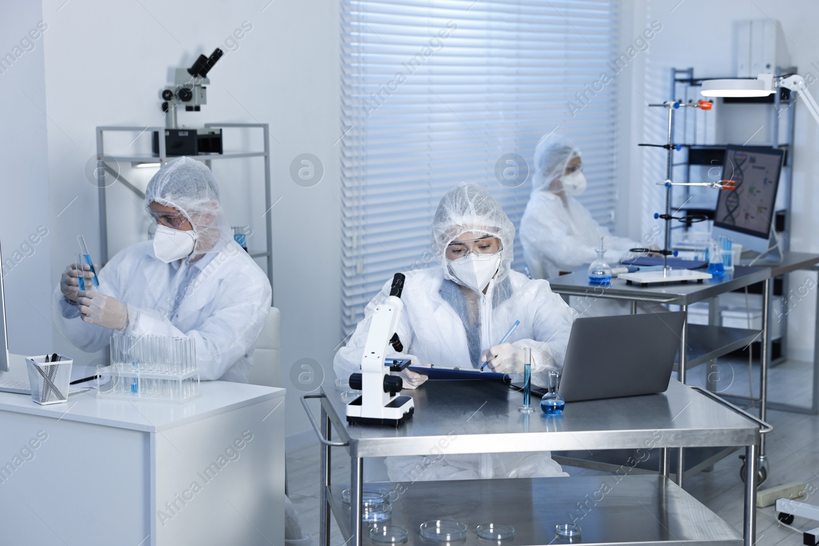 Photo of Scientists in protective suits working at laboratory