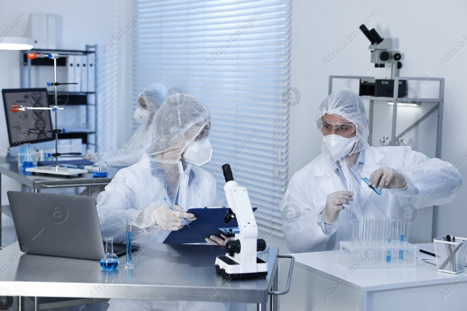 Photo of Scientists in protective suits working at laboratory