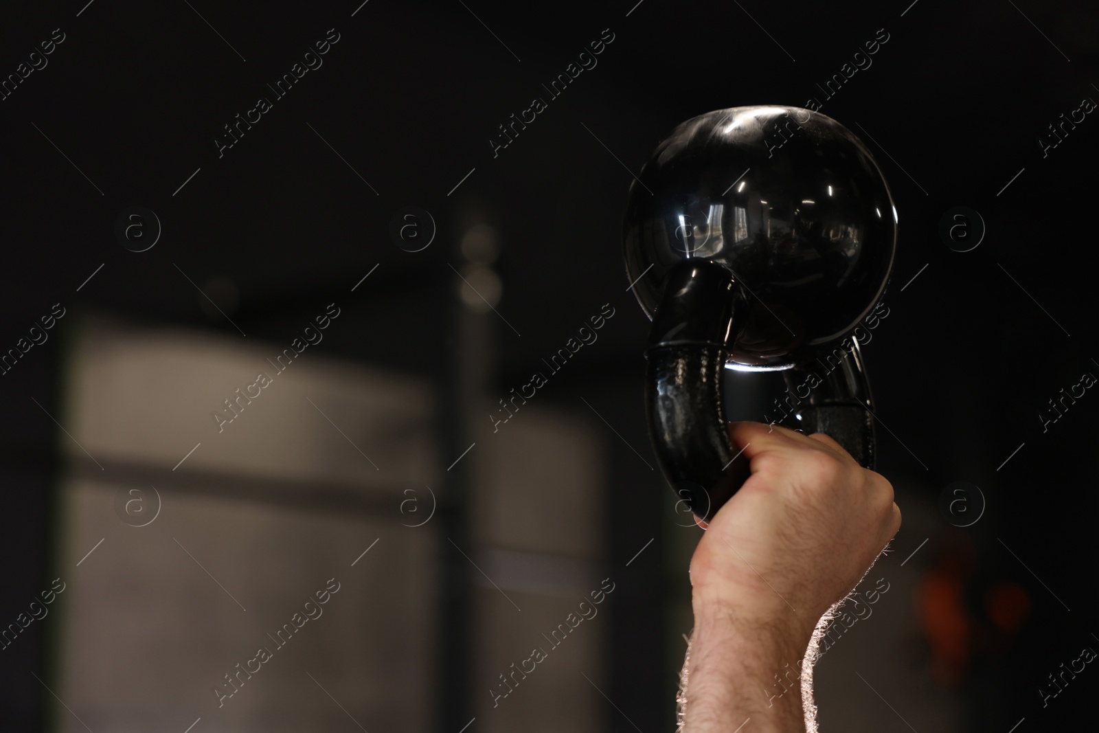 Photo of Sportsman with kettlebell during crossfit workout in gym, closeup. Space for text