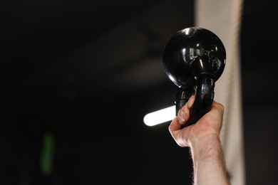 Photo of Sportsman with kettlebell during crossfit workout in gym, closeup. Space for text