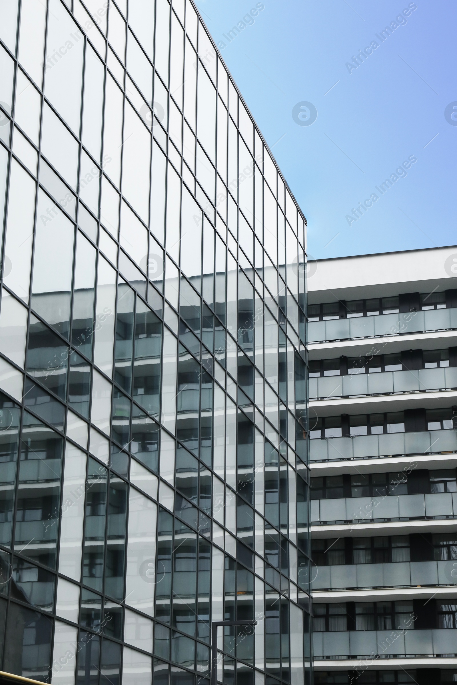 Photo of Modern buildings with many windows on city street