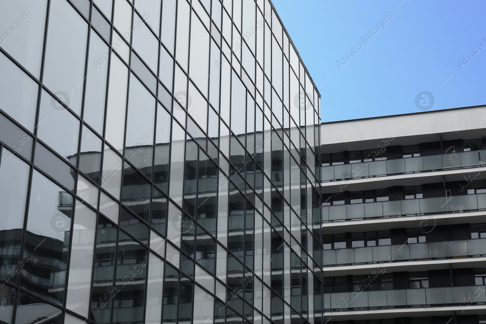 Photo of Modern buildings with many windows on city street