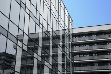 Photo of Modern buildings with many windows on city street