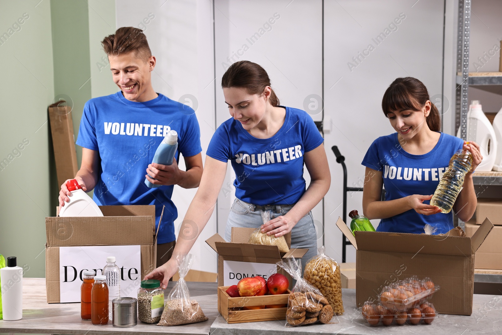 Photo of Volunteers packing food donations at tables indoors