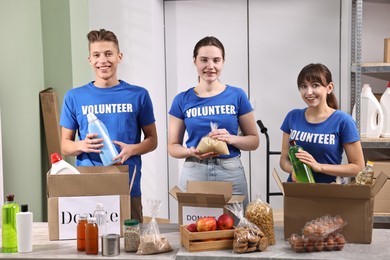 Photo of Volunteers packing food donations at tables indoors