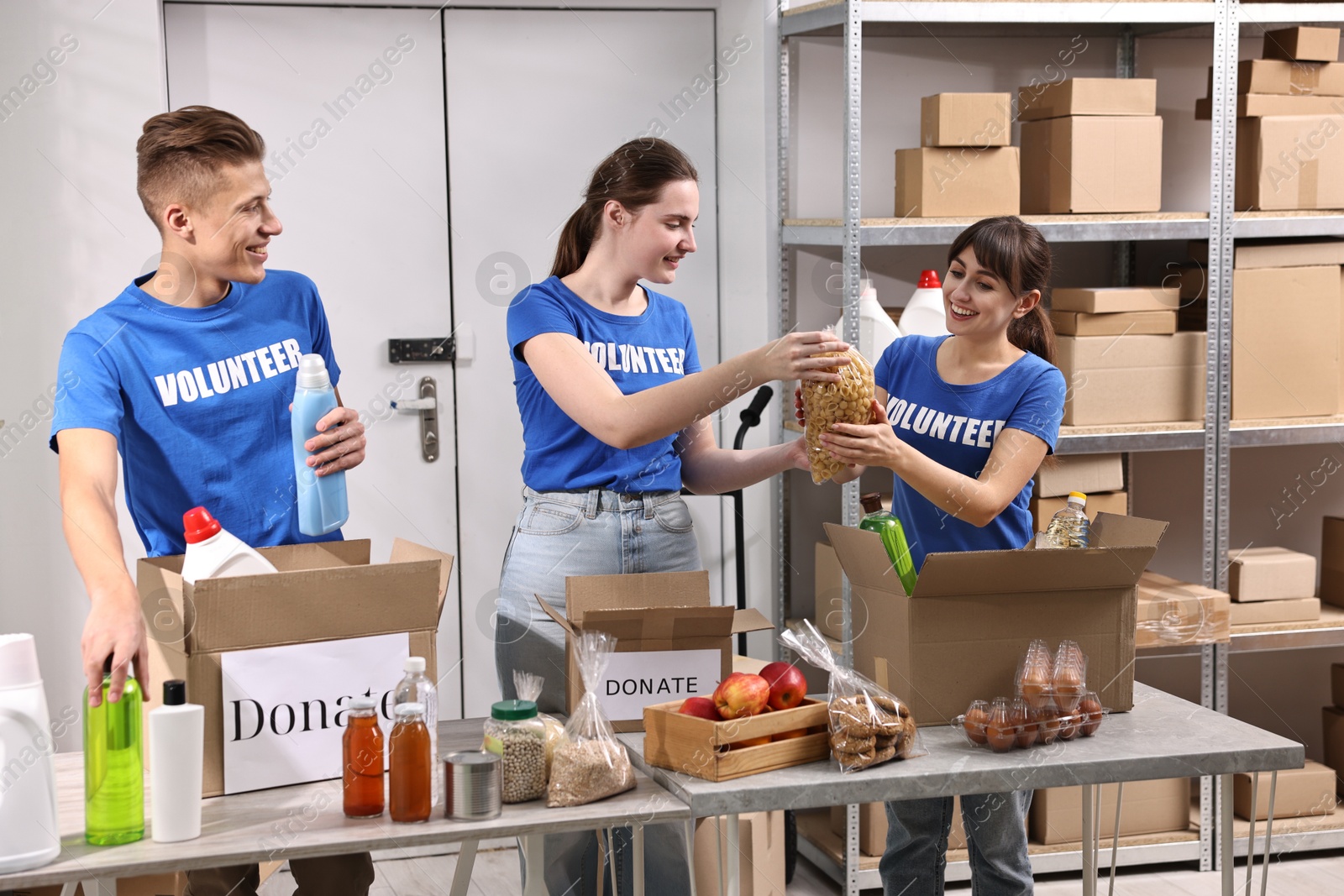 Photo of Volunteers packing food donations at tables indoors