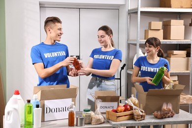 Photo of Volunteers packing food donations at tables indoors