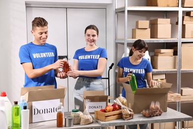 Photo of Volunteers packing food donations at tables indoors