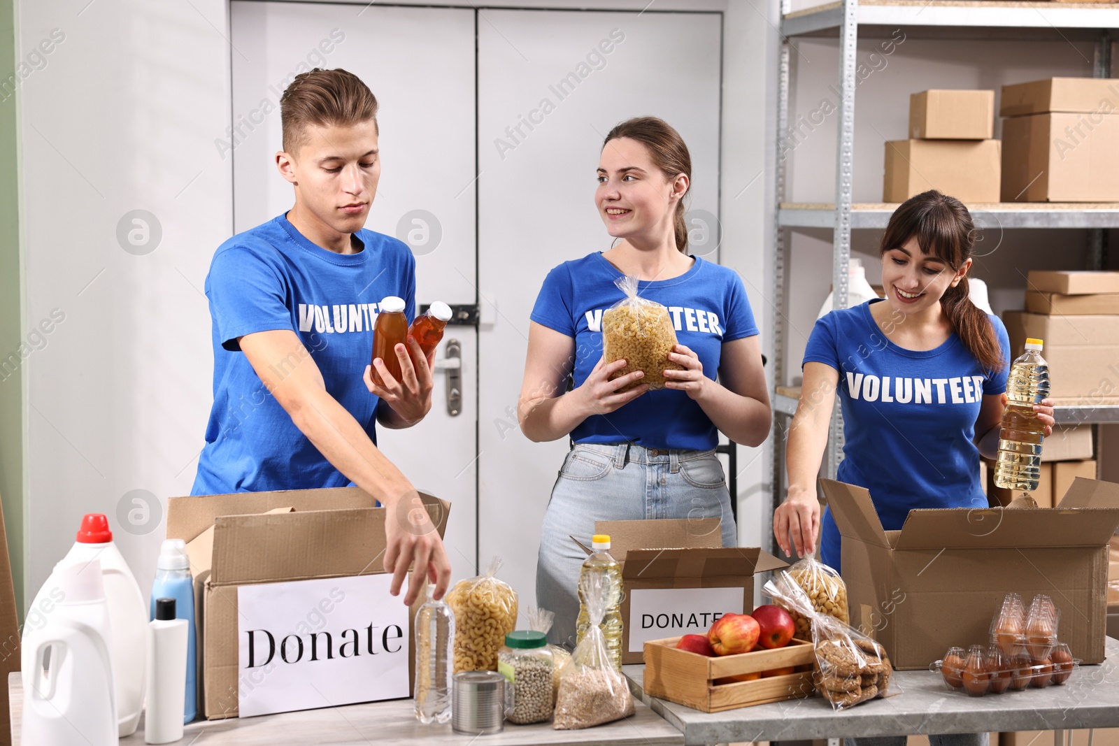 Photo of Volunteers packing food donations at tables indoors