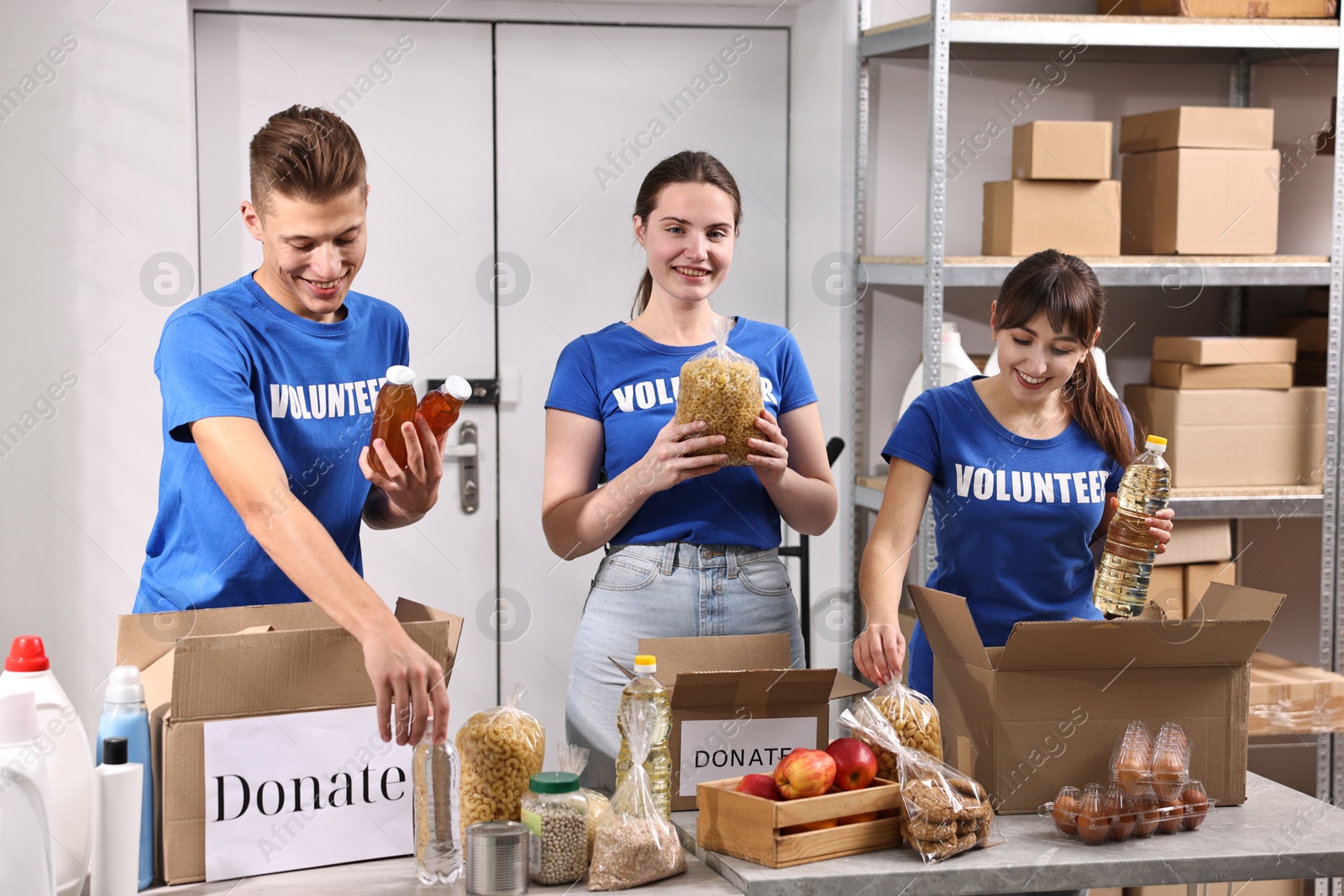 Photo of Volunteers packing food donations at tables indoors