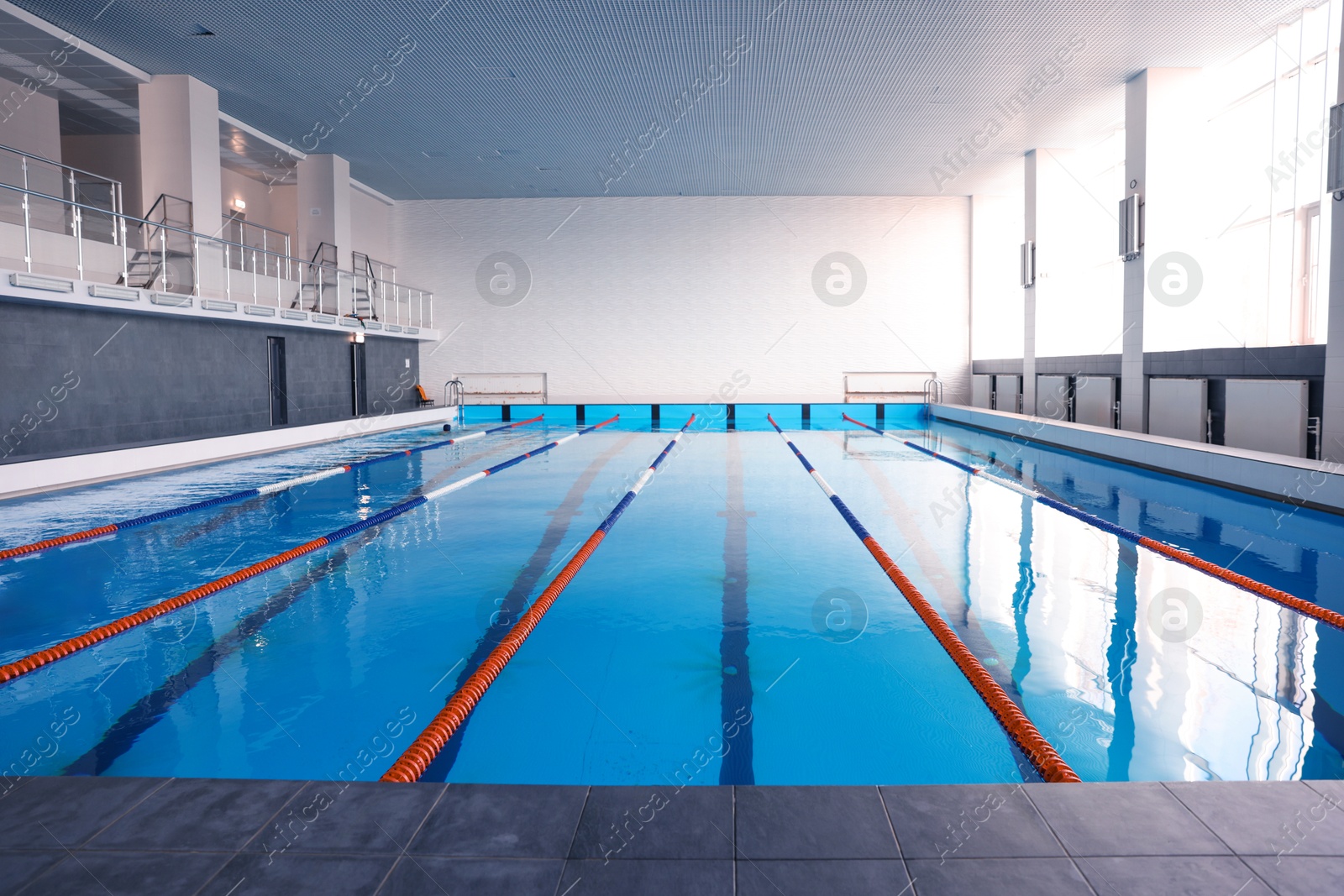 Photo of Swimming pool with clean water and lane dividers indoors