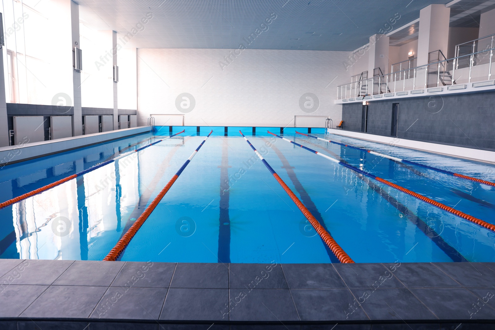 Photo of Swimming pool with clean water and lane dividers indoors