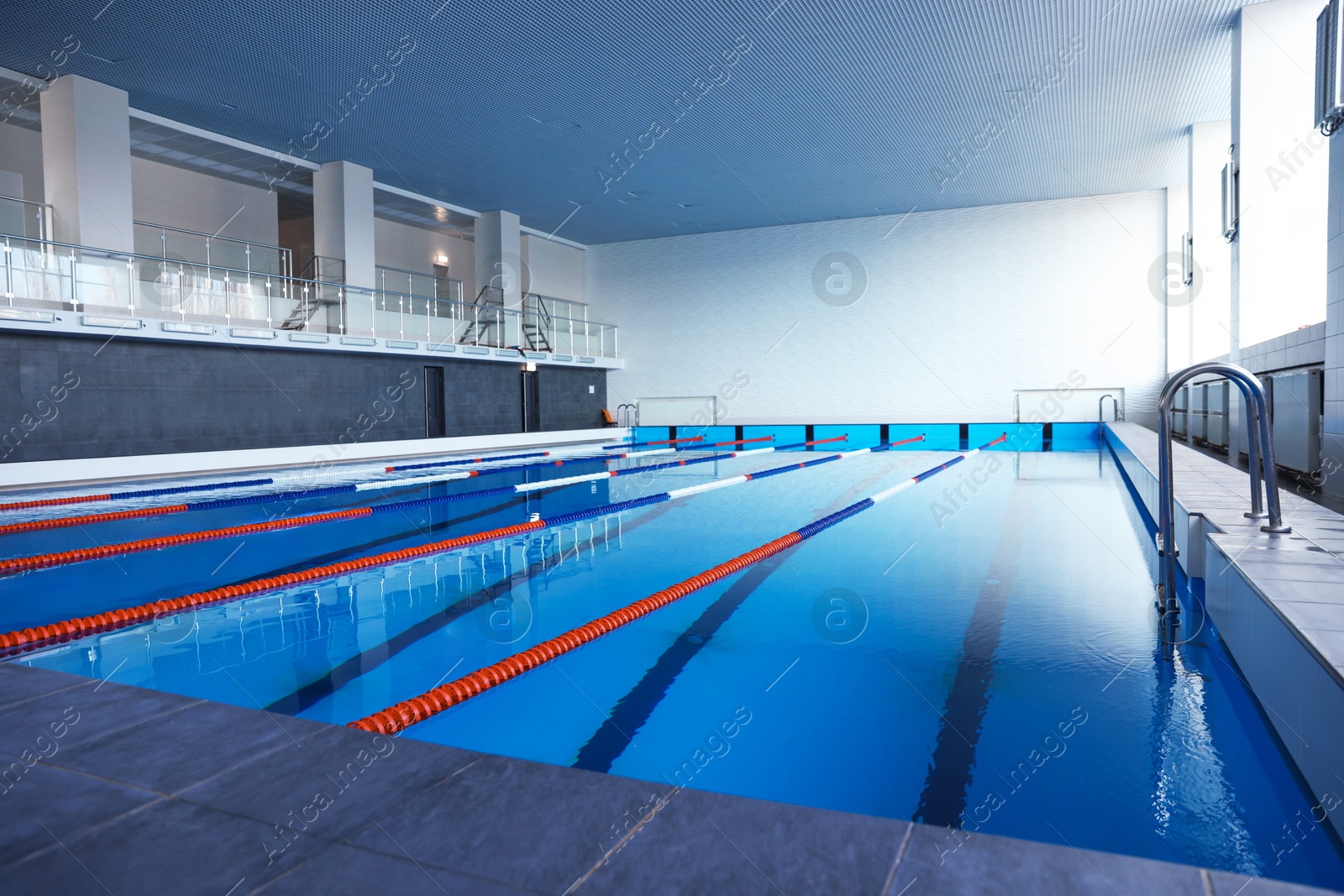 Photo of Swimming pool with clean water and lane dividers indoors