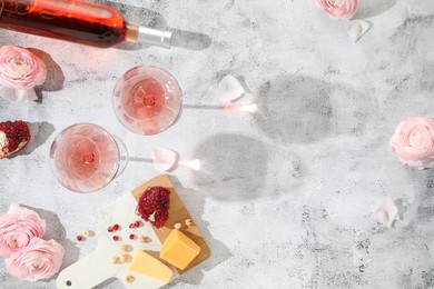 Photo of Flat lay composition with tasty rose wine and snacks on light textured table. Space for text