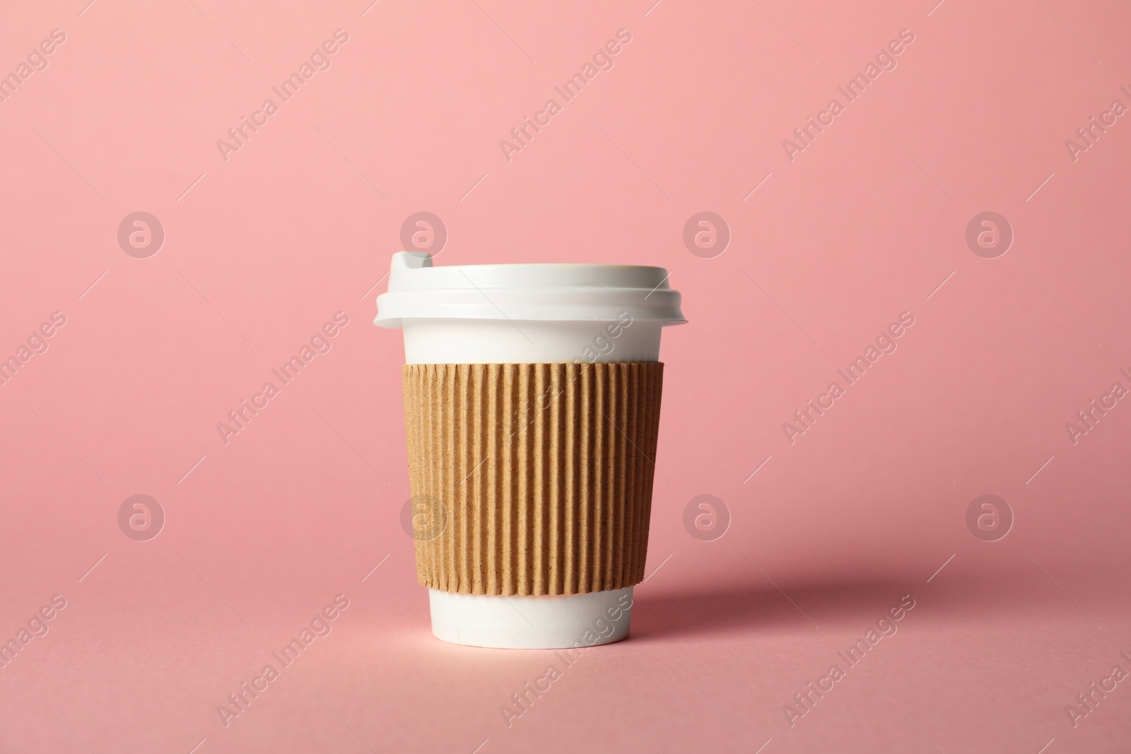 Paper cup on pink background. Mockup for design Photo of Paper cup on pink background. Mockup for design
