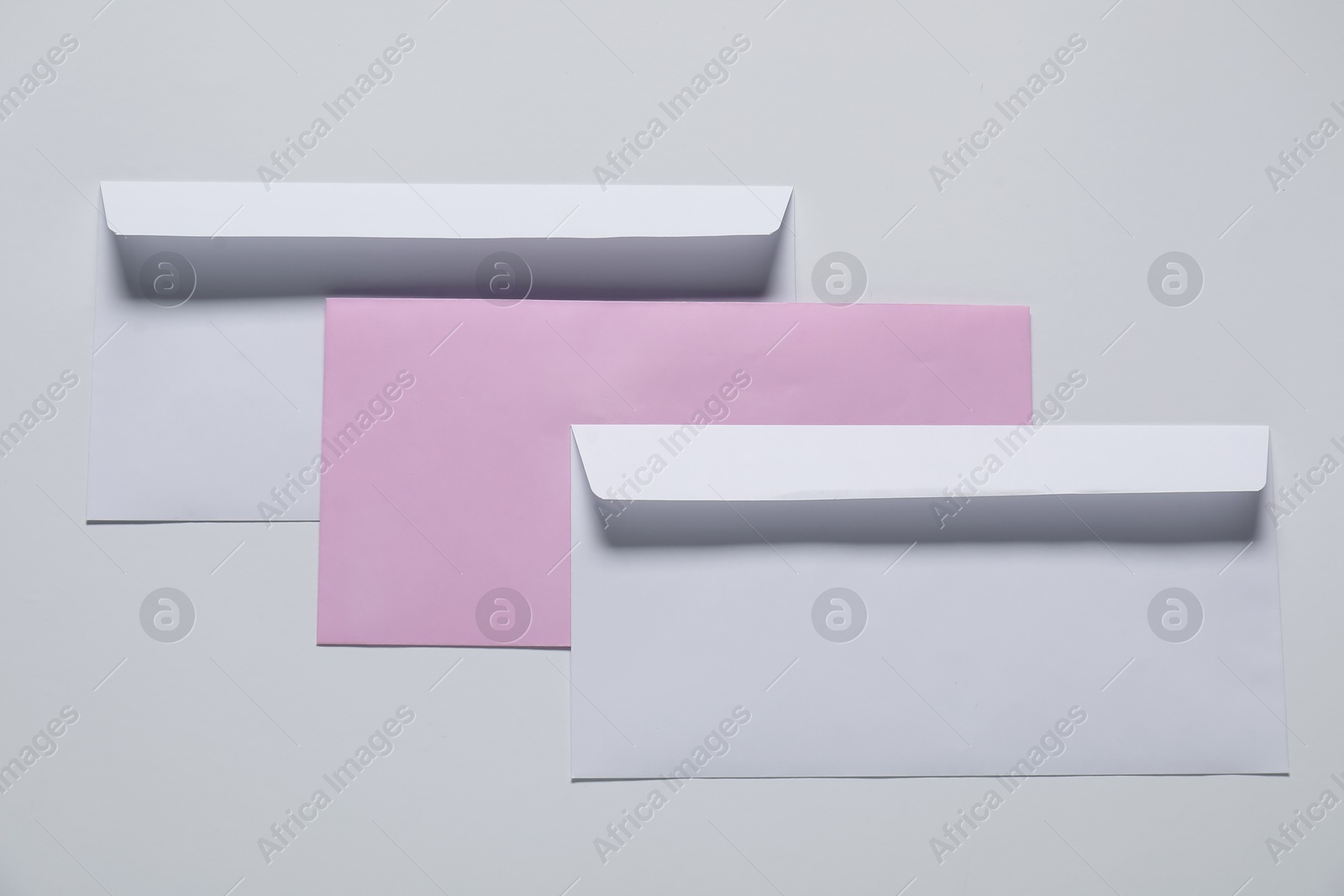 Photo of Paper envelopes on white background, top view. Mockup for design