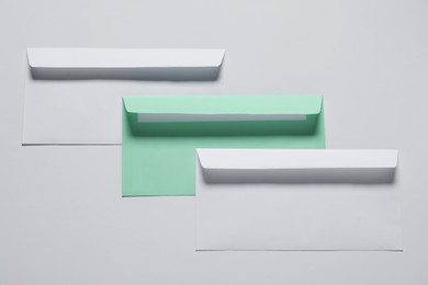 Photo of Paper envelopes on white background, top view. Mockup for design